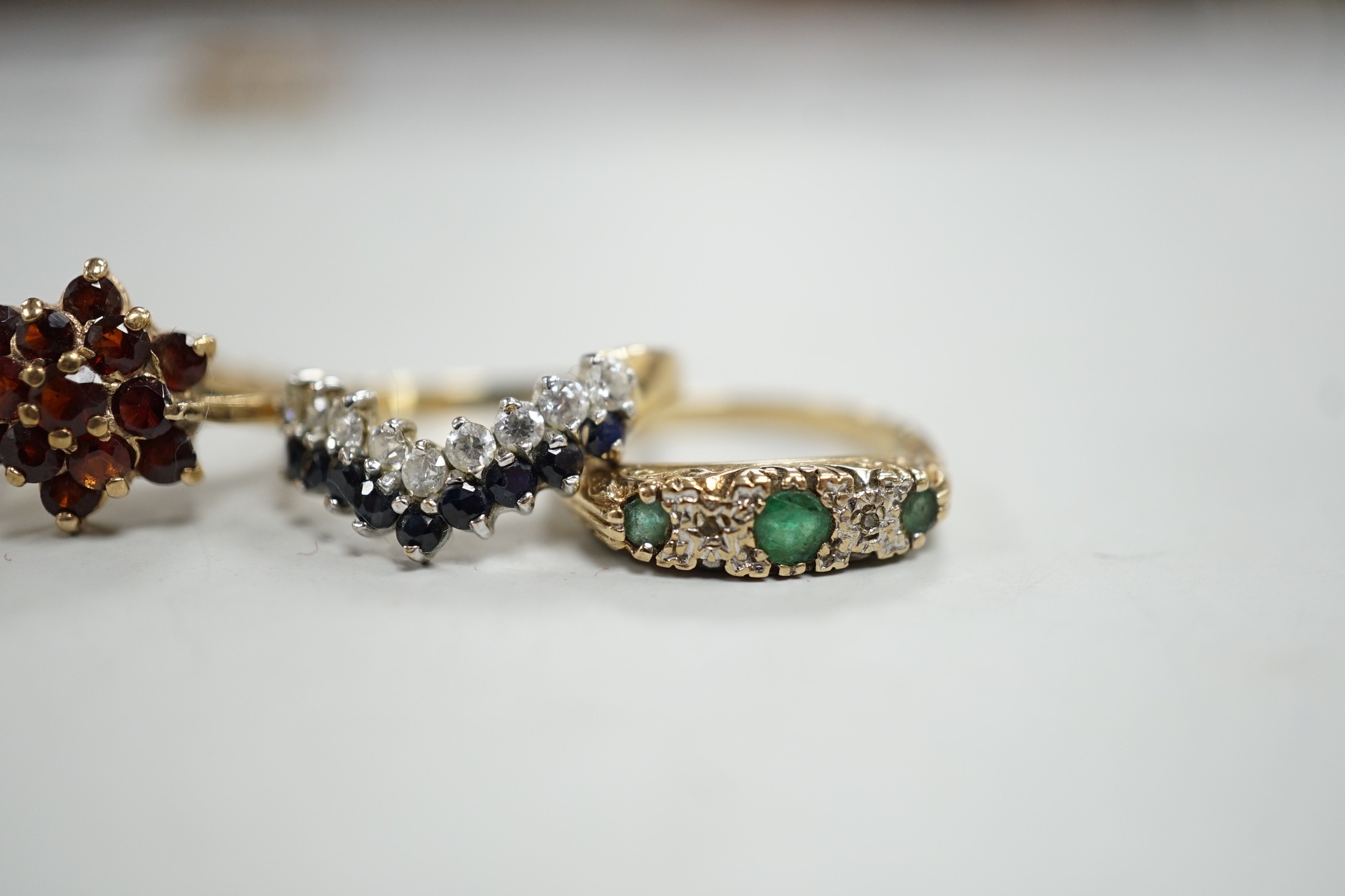 Four assorted modern 9ct gold and gem set rings, including a two stone diamond crossover, size K/L, gross 8.5 grams.